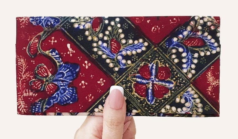 A hand holding Be Practical long wallet with Hand-drawn batik Lasem.