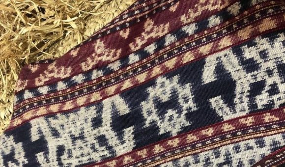 A piece of woven cloths on a straw bed, decor by Rasawastra.